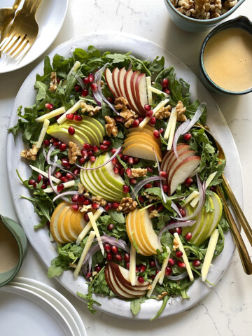 arugula pear salad walnuts pomegranate, plated