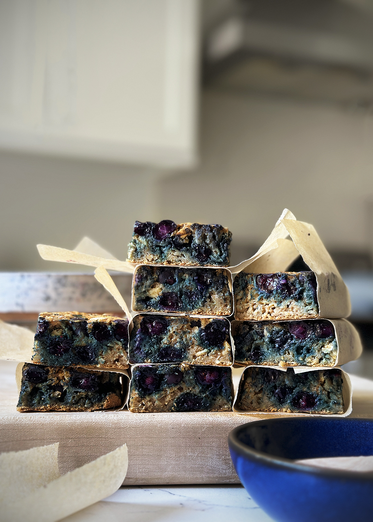 Blueberry Muffin Baked Oatmeal squares wrapped in parchment paper