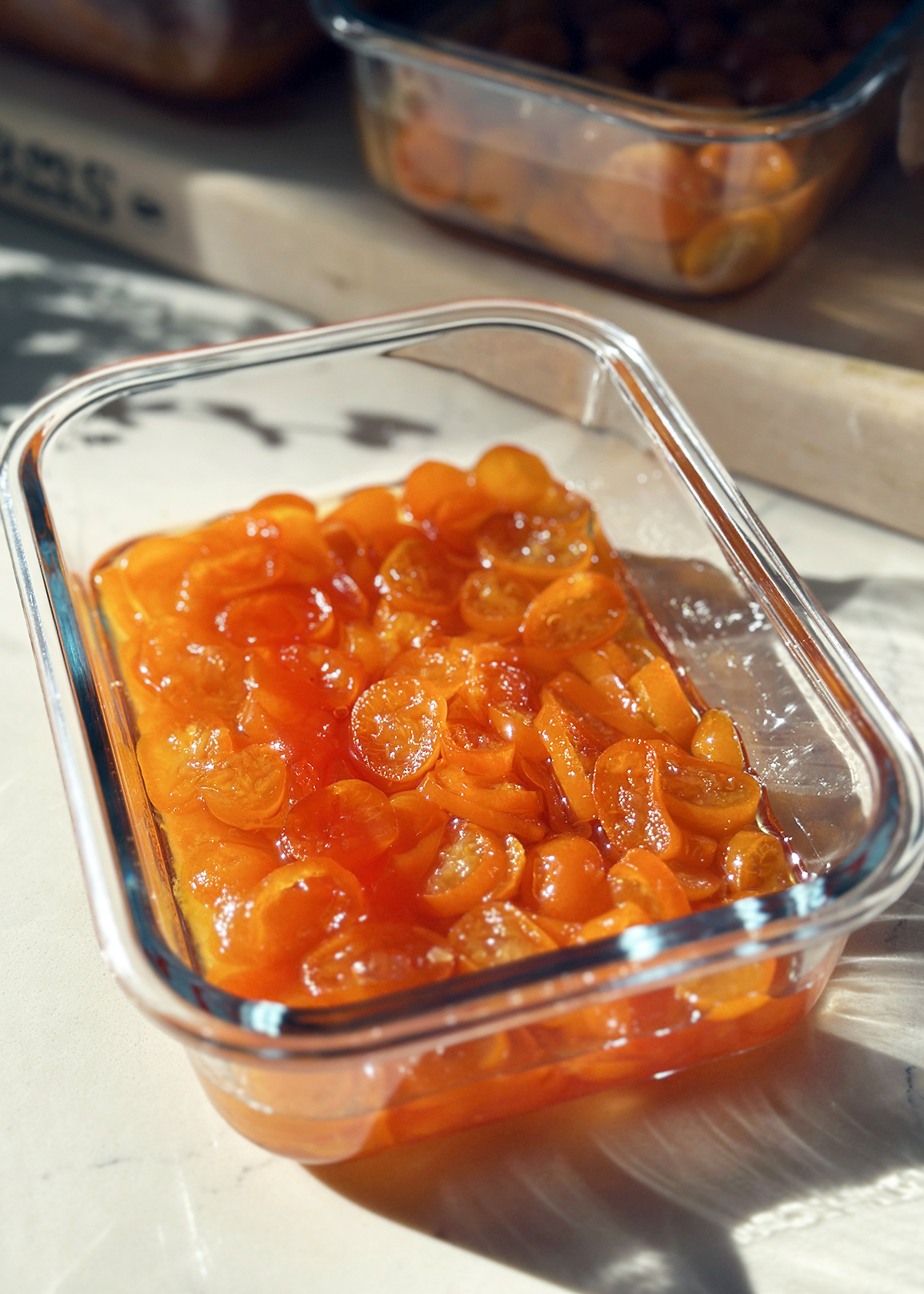 candied kumquats in glass container