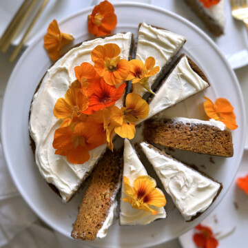 carrot cake, whole cake sliced on white cake plate