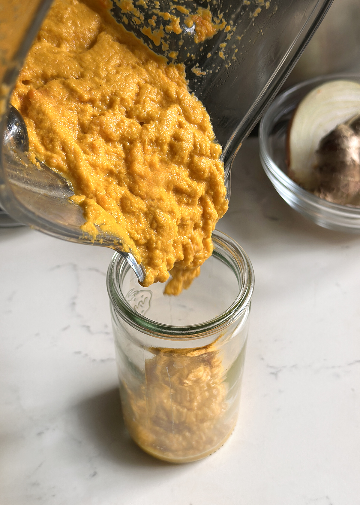 carrot ginger dressing pouring into jar
