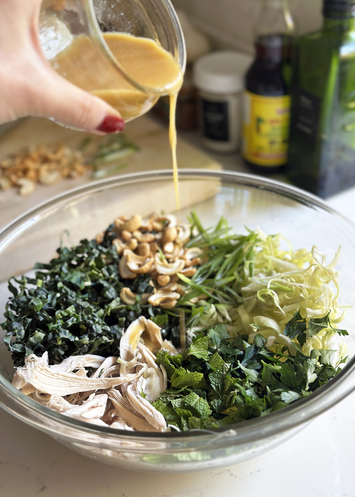 dressing over emerald kale salad