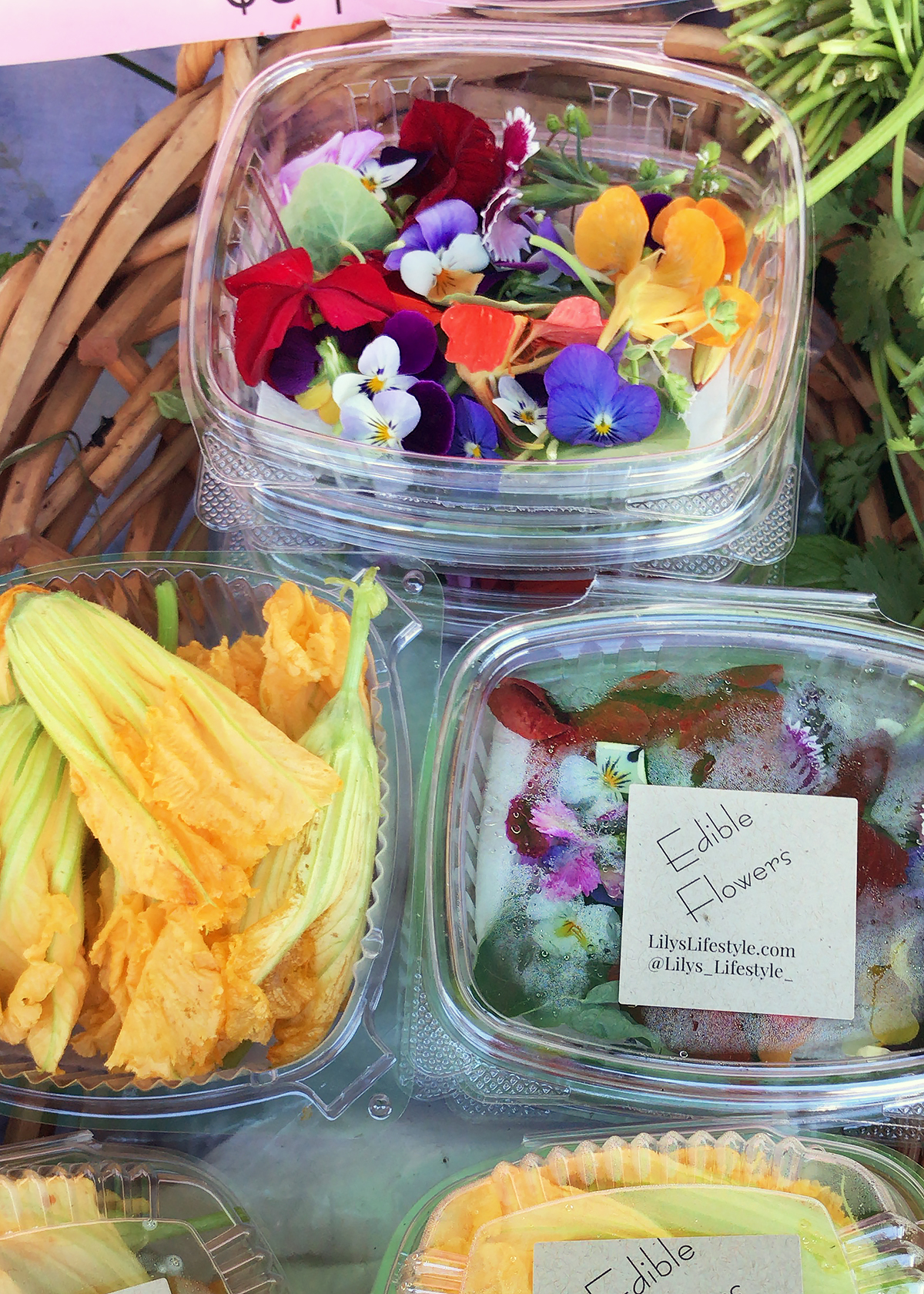 edible flower mix and squash blossoms at farmers market