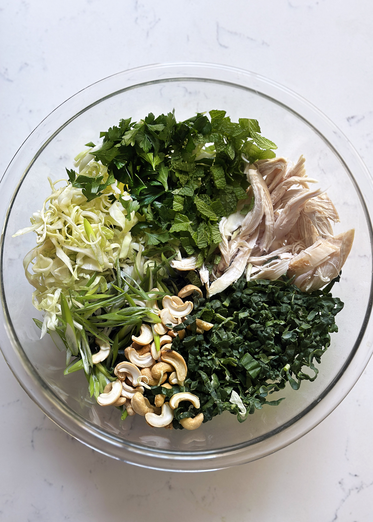 emerald kale salad ingredients in mixing bowl