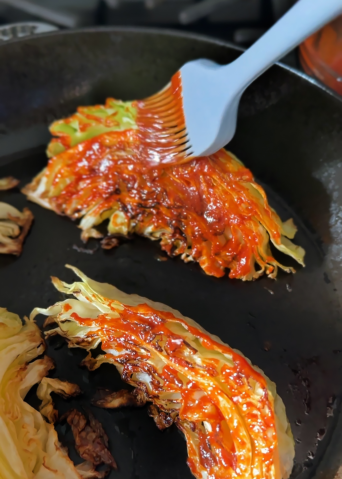 brushing gochujang on cabbage