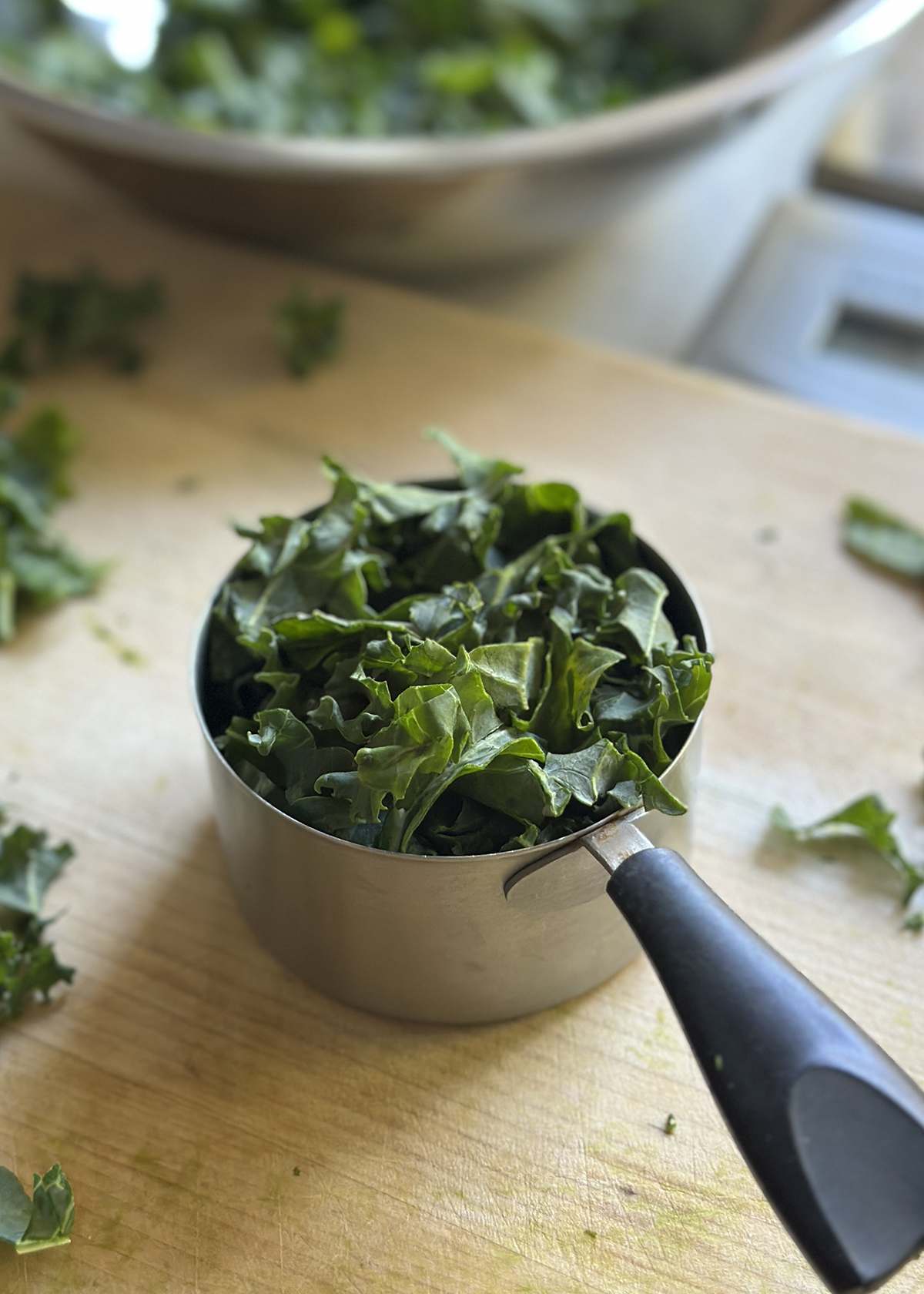 chopped kale in 1 cup measuring cup