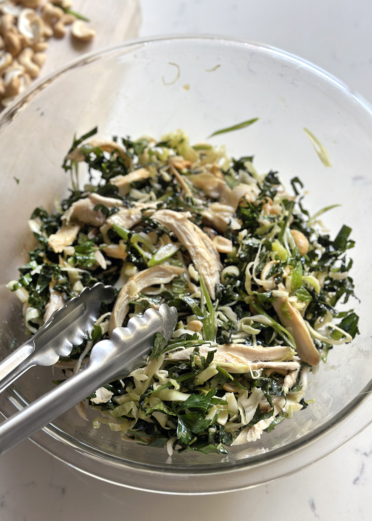 mixing kale salad and dressing