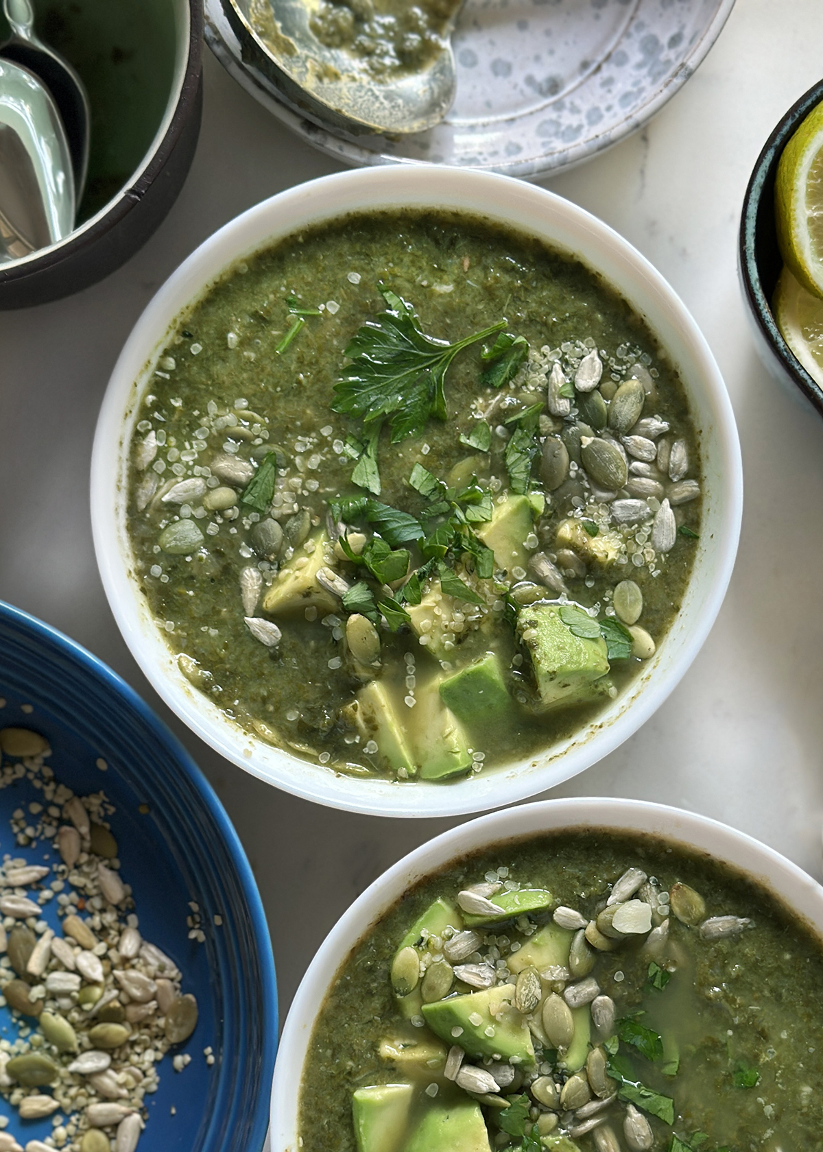 kale white bean soup in white bowls, garnished
