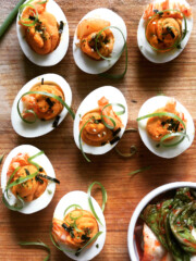 kimchi deviled eggs on wooden platter