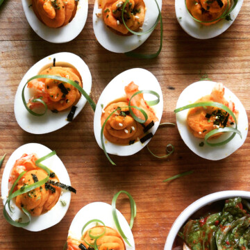 kimchi deviled eggs on wooden platter