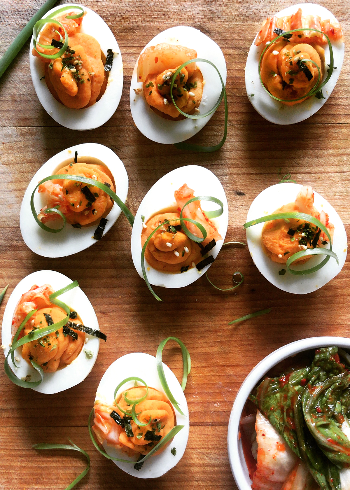 kimchi deviled eggs on wooden platter