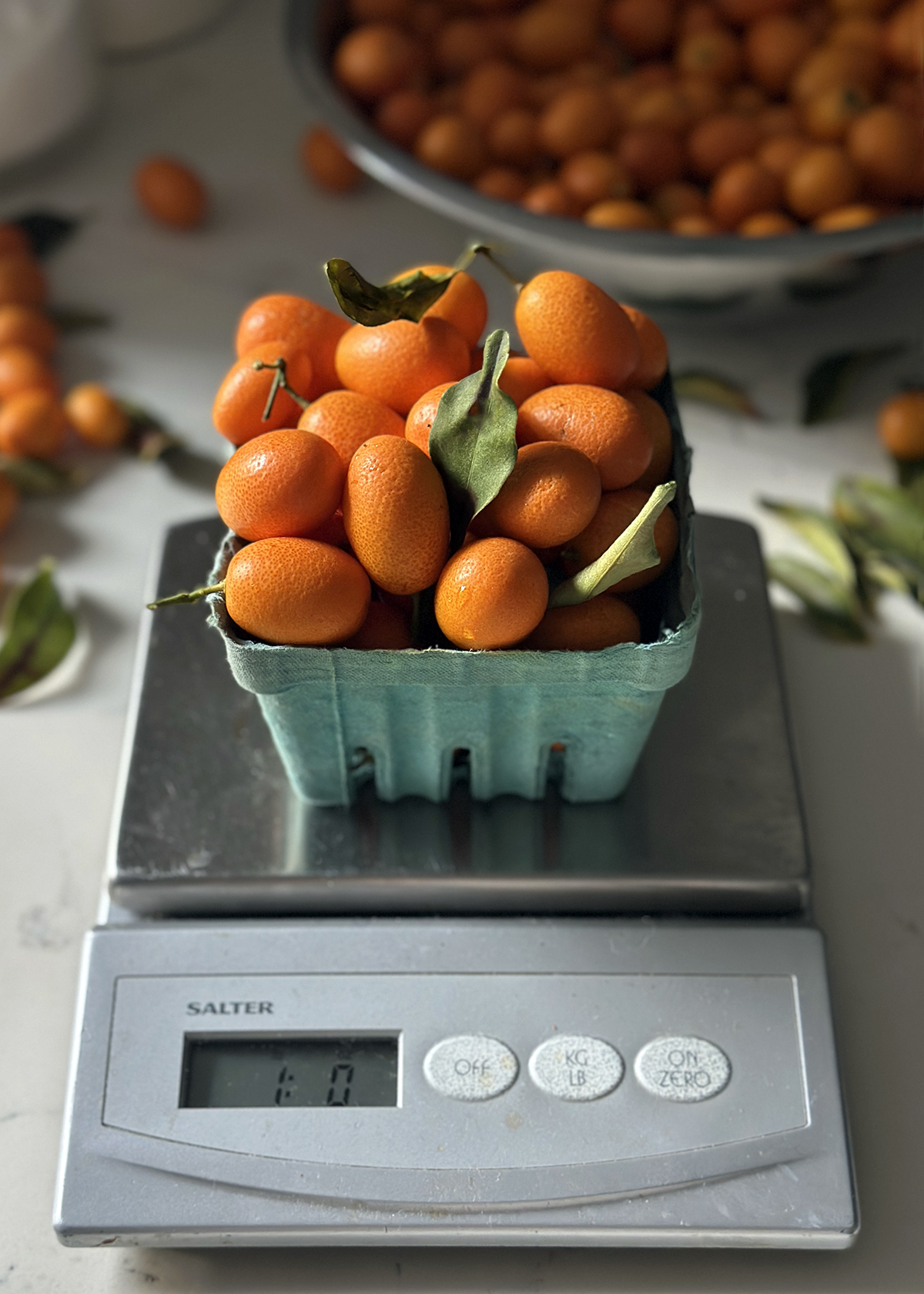 1 pound kumquats in basket on scale