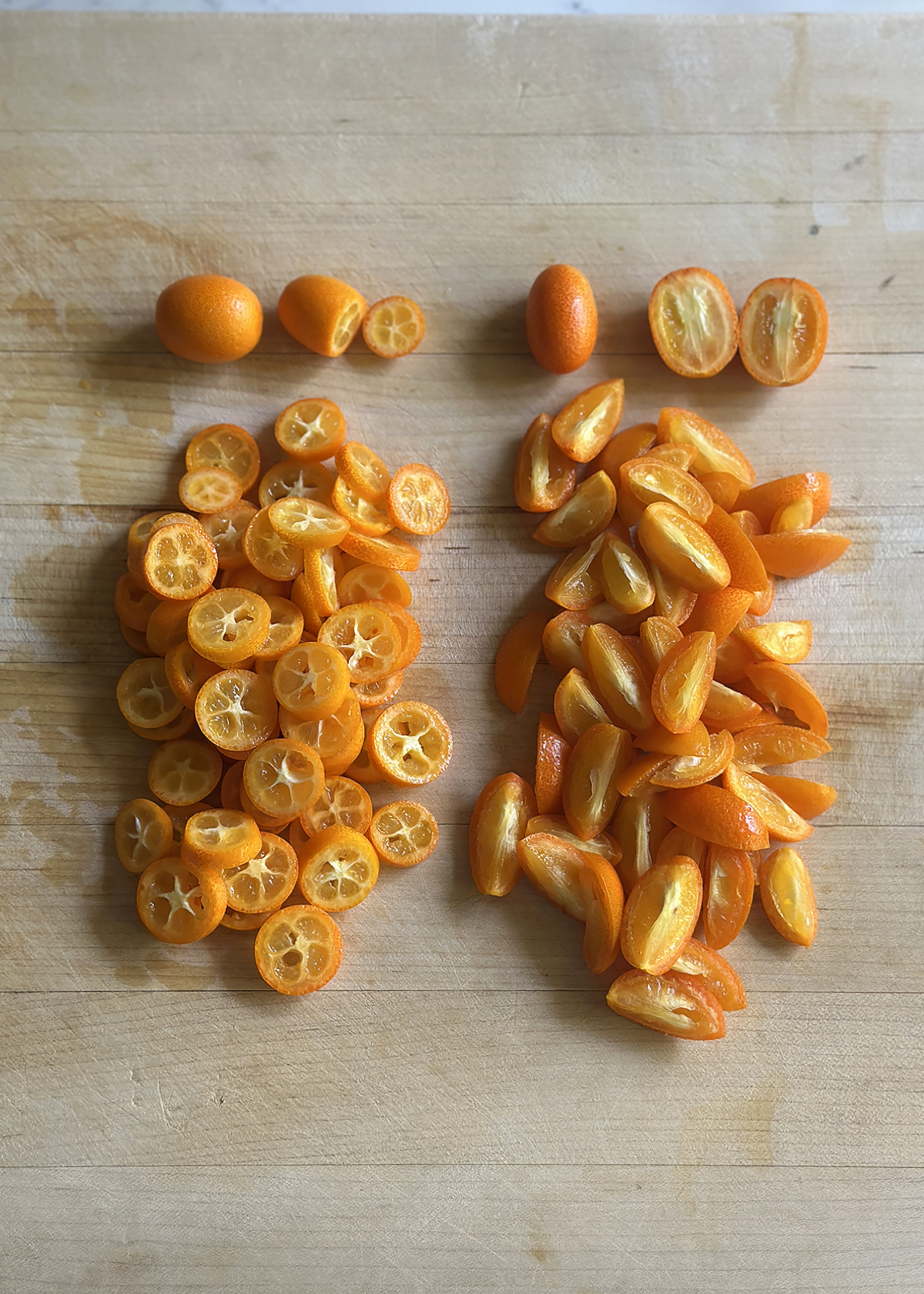 kumquats sliced cross-wise and lengthwise