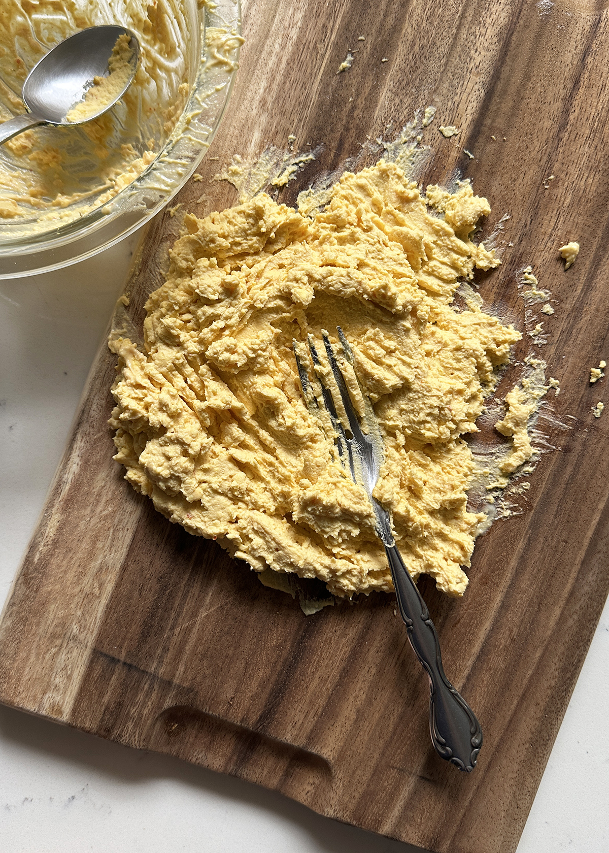 mashing yolks on cutting board