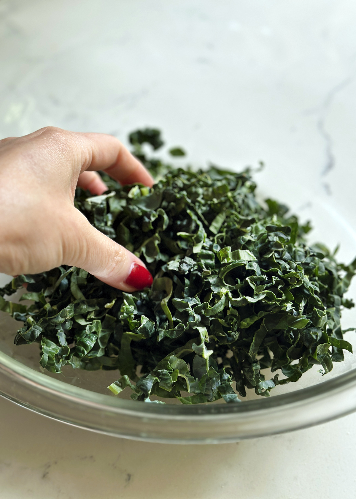 massaging tuscan kale in bowl
