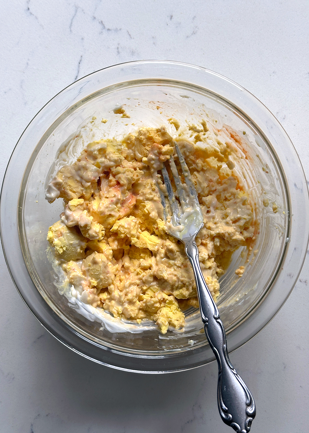 mashing egg yolks for deviled eggs