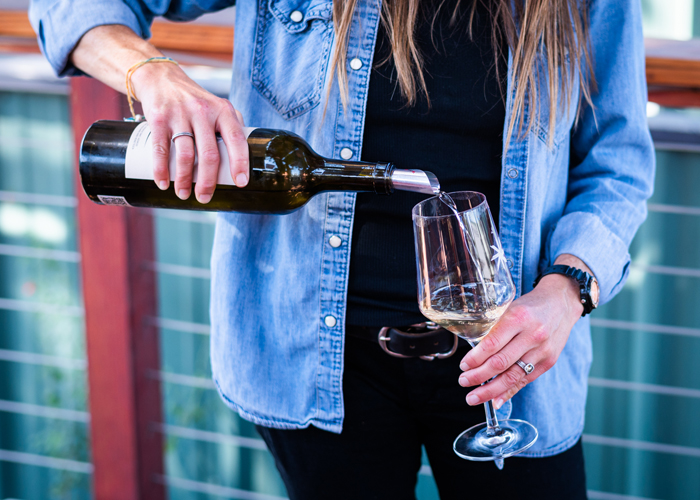 pouring white wine at outdoor wine tasting at Desparada Wines, Tin City, Paso Robles