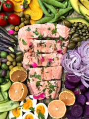 poached salmon garnished with rose herbs and rose petals with salad