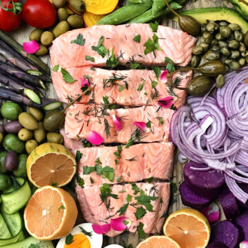 poached salmon garnished with rose herbs and rose petals with salad