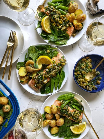 salmon with green olive salsa verde on plates