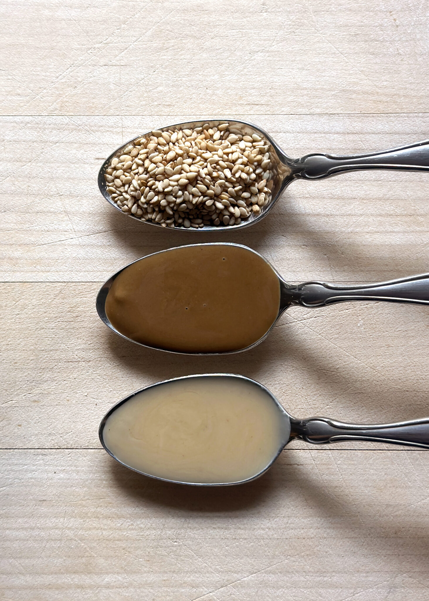 sesame seeds vs asian toasted sesame paste vs sesame tahini in spoons