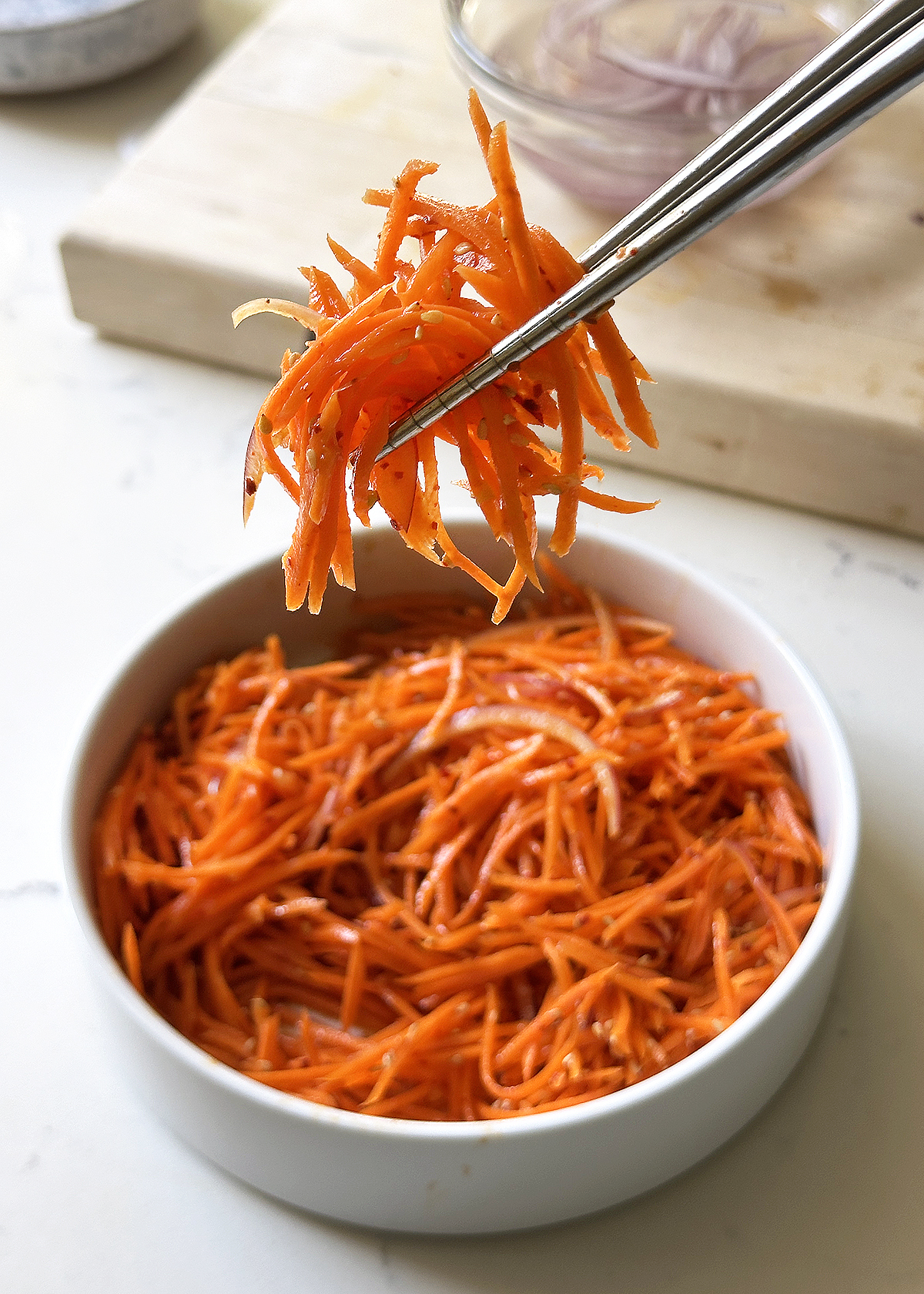 spicy carrot salad on chopsticks
