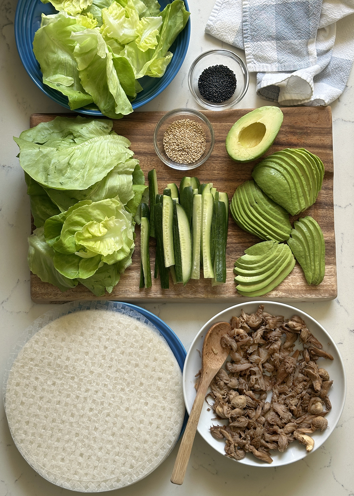 summer roll ingredients: avocado cucumber, mushrooms prepped on cutting board