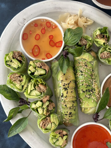 fish sauce vinaigrette dipping sauce with avocado summer rolls on platter