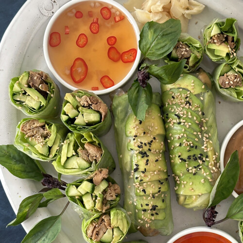 fish sauce vinaigrette dipping sauce with avocado summer rolls on platter